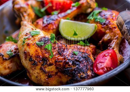 Grilled chicken legs lettuce and cherry tomatoes limet olives. Traditional cuisine. Mediterranean cuisine.