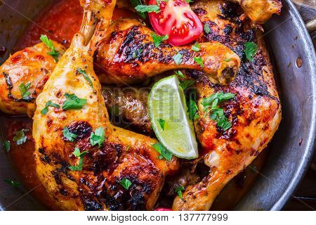 Grilled chicken legs lettuce and cherry tomatoes limet olives. Traditional cuisine. Mediterranean cuisine.
