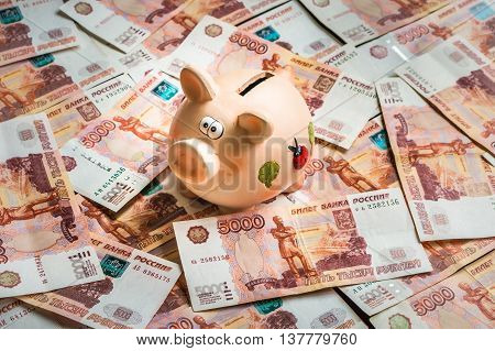 Piggy Bank In A Pile Of Russian Five Thousand Banknotes