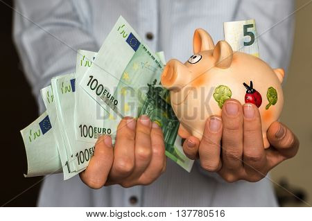 Young Woman With Piggy Bank And Euro Banknotes