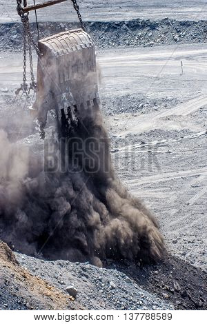 dredge ladle at open pit droping rocks