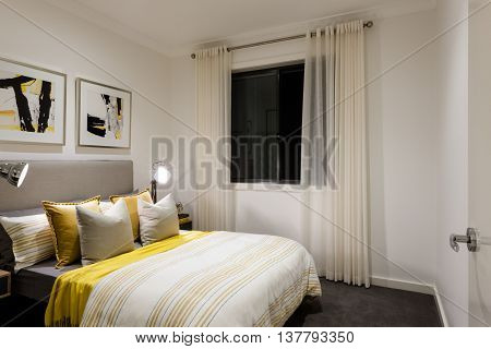 Classic Bedroom Of A Modern House With Table Lamps On