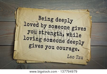Ancient chinese philosopher Lao Tzu quote on old paper background. Being deeply loved by someone gives you strength, while loving someone deeply gives you courage.