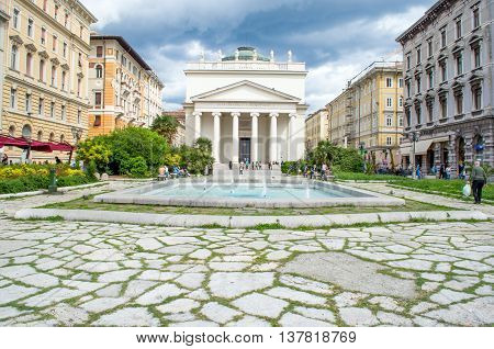 Trieste Italy June 1 2013: fountain in the San Antonio plaza in front of the Taumaturgo church.