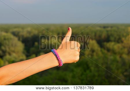 сhild's hand with a bracelet thumbs up