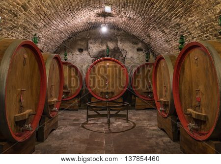 Wine barrels in a Montepulciano cellar Tuscany