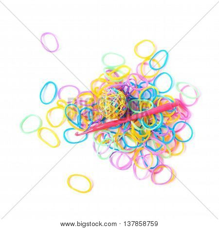 Pile of multiple colorful rubber toy loom bands isolated over the white background