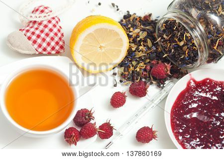 Tea lemon jam and red raspberry berries on white