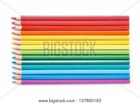 Multiple colorful color pencils composition arranged in a line to form a rainbow gradient, composition isolated over the white background