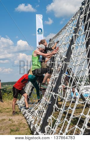 Tyumen, Russia - July 9, 2016: Steel Character extrim race on Voronino Hill. Nets stage. Team storms net wall