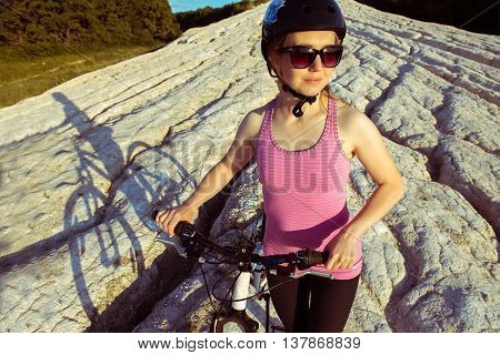 a beautiful young woman rides a bike on the nature day