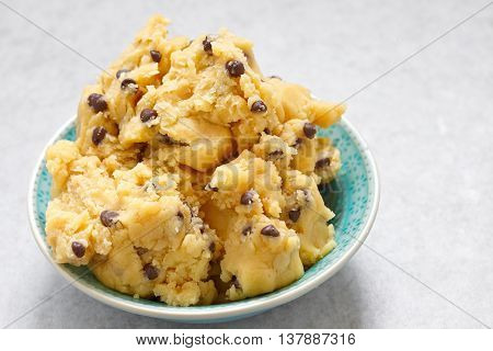 Sweet cookie dough with chocolate chips on a table
