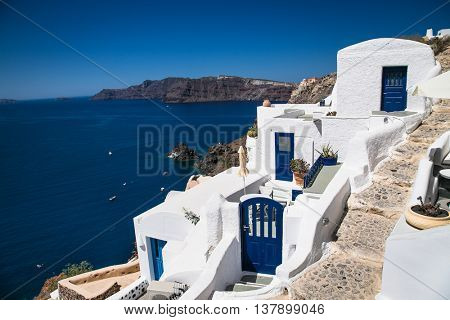 Blue doors in Oia village at suny day on Santorini island, Greece.