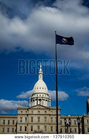 Michigan state capital and state flag flying over it