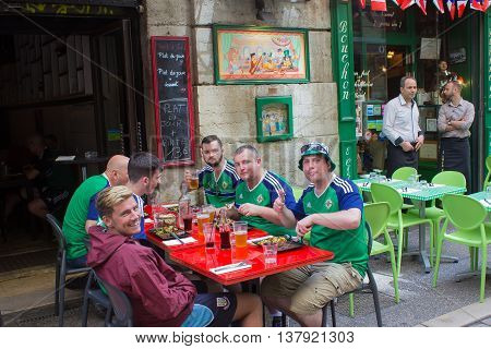Lyon, France - June 16, 2016: Northern Ireland fans sitting at in a restaurant in Lyon at the European Football Championship EURO 2016