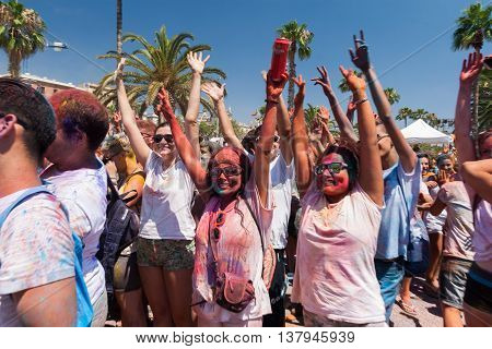 BARCELONA SPAIN - JULY 9 2014: Participators of Holi festival at Escenario del Moll de la Fusta have fun.
