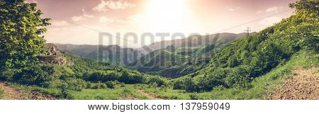 Ancient monastery in setting sun. Tatev. Armenia