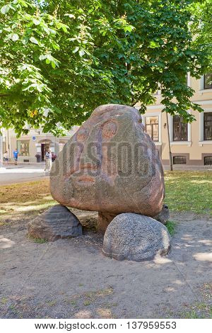 RIGA LATVIA - JUNE 7 2016: Replica of the original Stone Head in Salaspils set in Livu Square in Riga Latvia (UNESCO site). Stone Head is a paganic idol sculpture of the early Iron Age