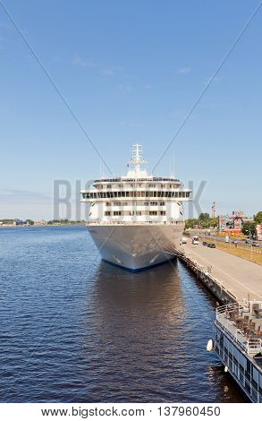RIGA LATVIA - JUNE 7 2016: 12 decks MS The World (IMO 9219331) in the port of Riga Latvia. The World is the largest privately owned residential yacht (165 apartments gross tonnage 43524 tons)