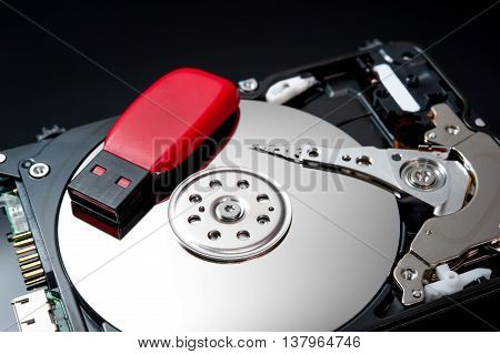 USB Flash Drive on hard disk drive close up