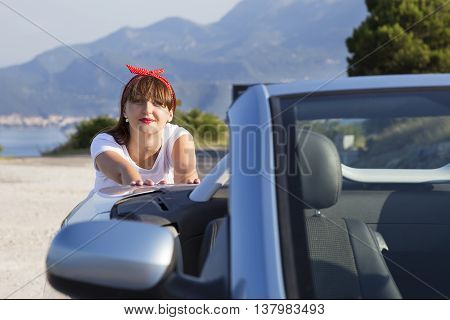 Young woman push the car runs out of gas.