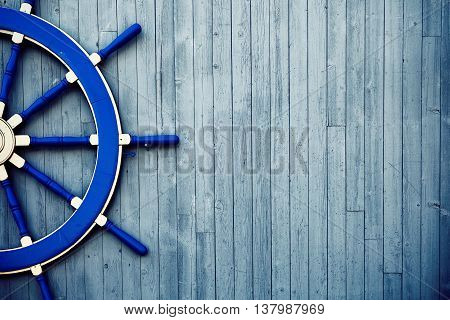 Old Vintage Blue Wooden Helm Wheel on the wall