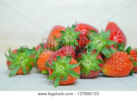 Strawberry fruit with flash filled on wooden board (Also known as Fragaria strawberry Fragaria ananassa)