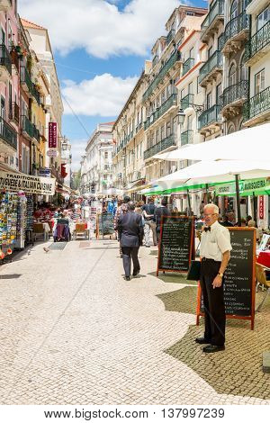 LISBON, PORTUGAL - MAY 26: Unidentified tourists are walking at Santo Antao street  on May 26, 2014 at Lisbon. Santo Antao street is a lively pedestrian street known for its seafood restaurants.