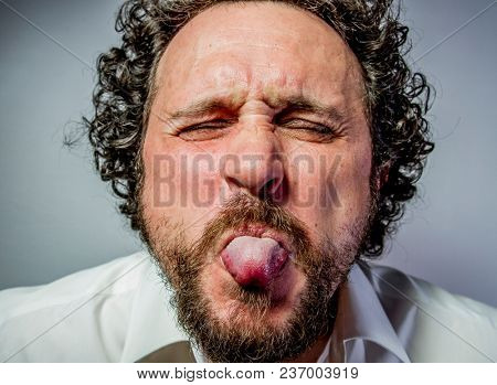 derision, man with intense expression, white shirt