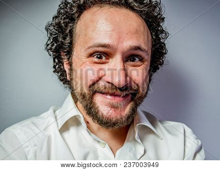 derision, man with intense expression, white shirt
