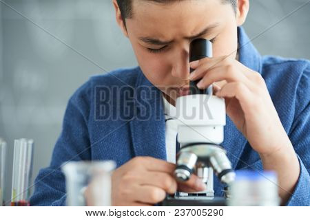 Close-up Shot Of Curious Teenager Looking Through Microscope While Examining Sample At School Labora