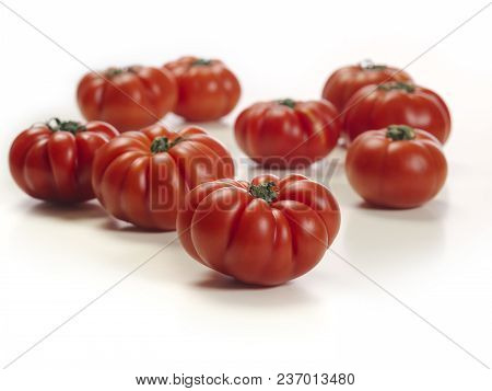 Photo Of A White Table Top With Marmande Tomatoes.