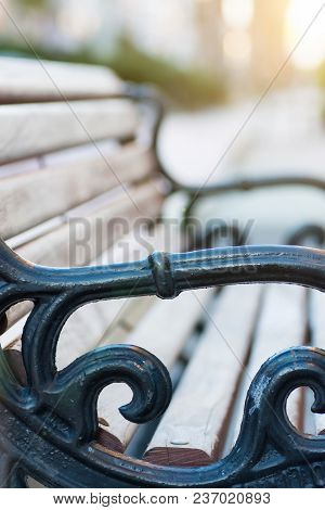One Empty Wooden And Metal Bench In City. Urban Landscape. Goolden Sunlight Flare. Tranquility Conte