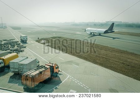 A Passenger Plane Being Serviced By Ground Services Before Next Takeoff. Pushback Tug, Passenger Boa