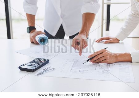 Architect Or Engineer Meeting Working With Partner On Blueprint For Architectural Project In Progres