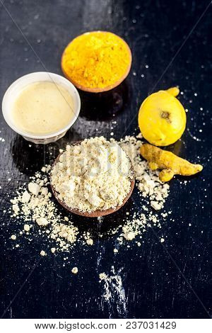 Chana,haldi,limbo Ka Ubtan Or Ayurvedic Face Pack Of Turmeric, Lemon, And Gram Flour On Wooden Surfa