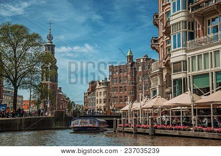 Amsterdam, Northern Netherlands - June 26, 2017. Canal With Brick Building, Restaurant, Touristic Bo