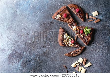 Sliced Homemade Sweet Dessert Chocolate Pizza With Different Chocolates, Raspberries And Mint With I