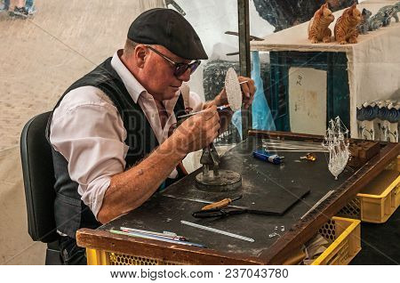 Gouda, Southern Netherlands - June 29, 2017. Skilled Craftsman Working With Fire To Make Glass Sculp