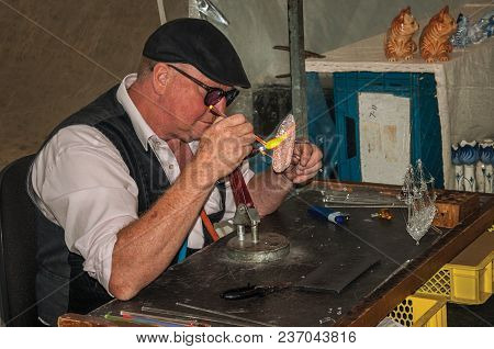Gouda, Southern Netherlands - June 29, 2017. Skilled Craftsman Working With Fire To Make Glass Sculp