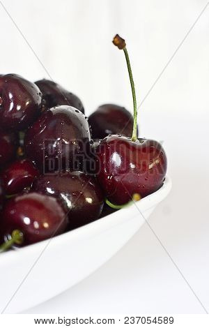 Beautiful Juicy Fresh Summer Cherries In A White Bowl On A Vintege Background