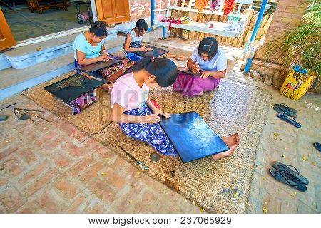 Bagan, Myanmar - February 24, 2018: Women Sit On The Floor In Workshop And Scratch Lacquerware Surfa