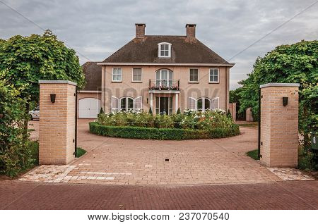 Drimmelen, Southern Netherlands - June 30, 2017. Entrance Gate Open To Courtyard Garden In Elegant B