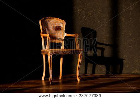Old Chair On A Black Gray Wall Background