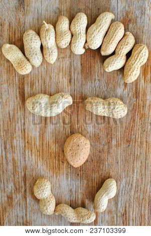 Smiling Peanuts With Diferent Nose On Wooden Background