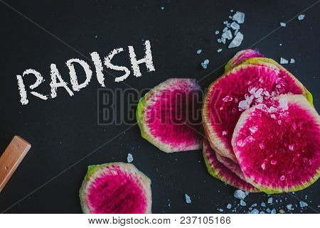 Watermelon Radishes Sliced, Sprinkled With Sea Salt On A Black Background