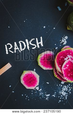 Watermelon Radishes Sliced, Sprinkled With Sea Salt On A Black Background