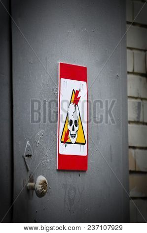 High Voltage Danger Yellow Sign On A Brick Wall Building