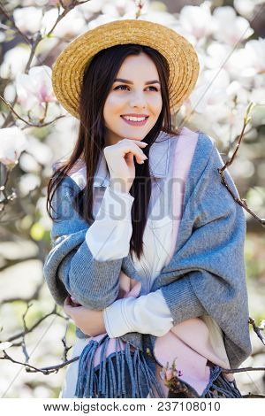 Happy Outside. Pensive Beautiful Girl In Straw Hat Looking Up Smiling Holding Touching Hat Isolated
