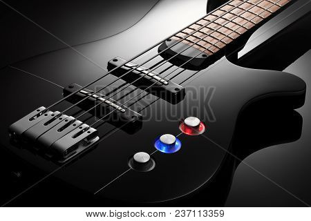 Close Up On The Body Of Elegant Black Bass Guitar, Black Glossy Background